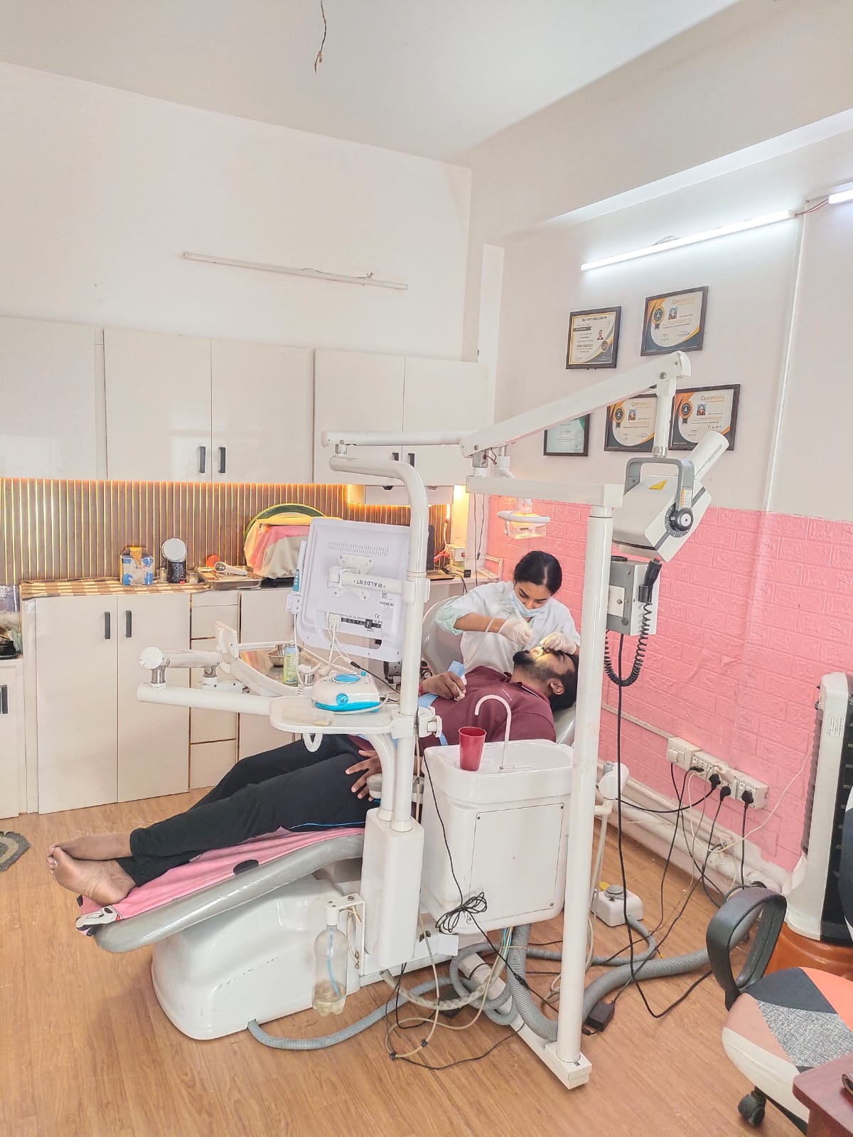 Dentist treating a patient in the treatment room